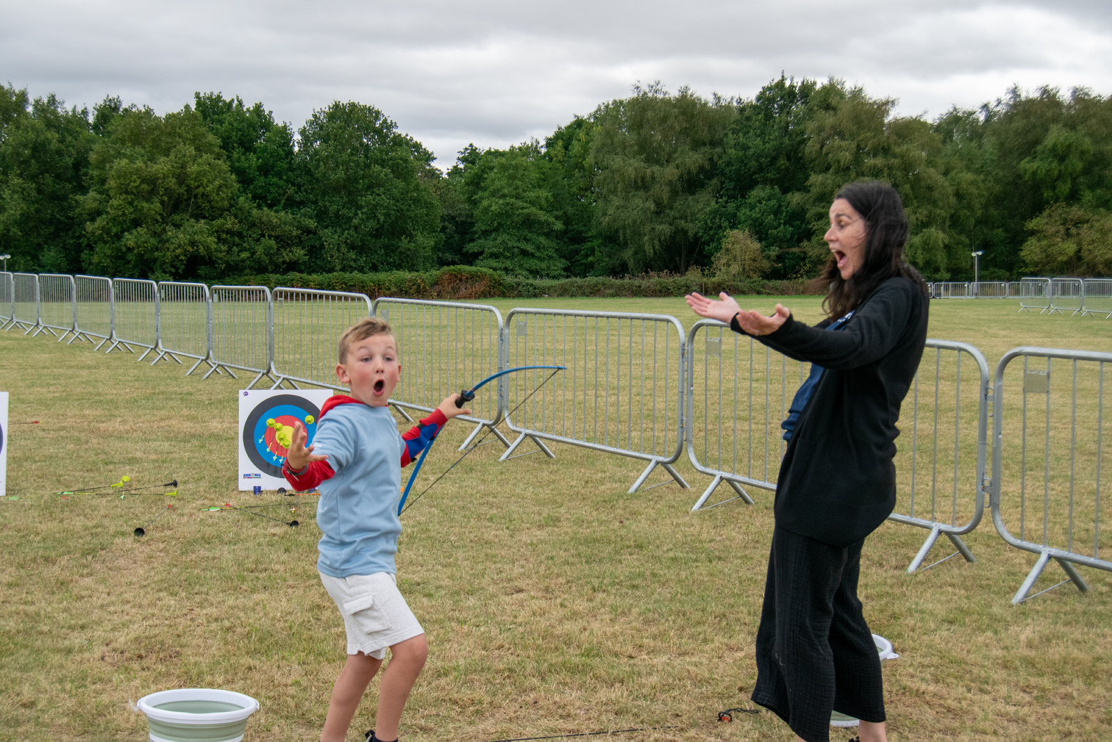 Gayle Pink and a child trying archery
